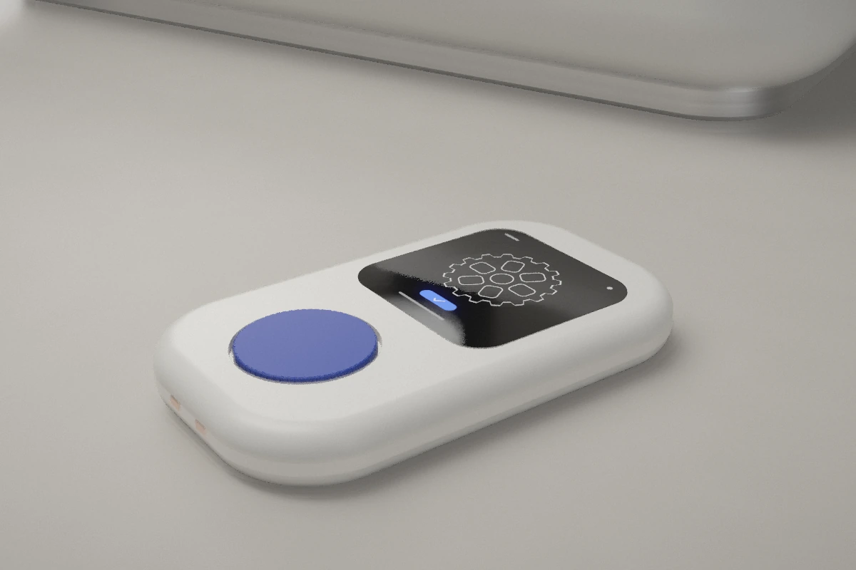 Concept render of the SRAM handheld lying on a desk, its screen showing a gear design beside a cobalt-blue dial